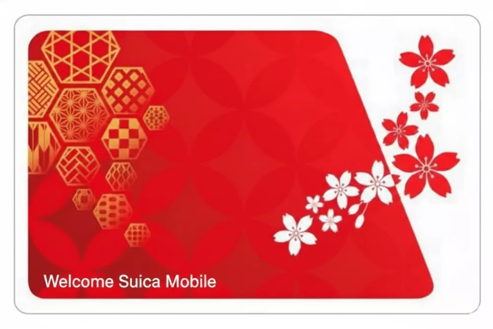 The red Welcome Suica card designed for tourists visiting Japan, with sakura cherry blossom patterns.