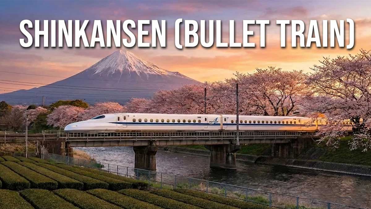 The Shinkansen bullet train passing over a bridge with Mount Fuji and cherry blossoms in the background at sunset. Text overlay at the top reads "SHINKANSEN (BULLET TRAIN)".